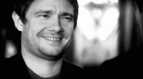 A Black And White Photo Of A Man Smiling And Making A Face . GIF