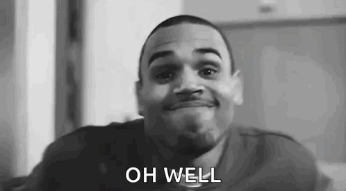 A Black And White Photo Of A Man Smiling With The Words `` Oh Well '' Written On His Face . GIF