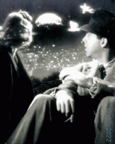A Black And White Photo Of A Man Smoking A Cigarette With The Date 10 2022 GIF