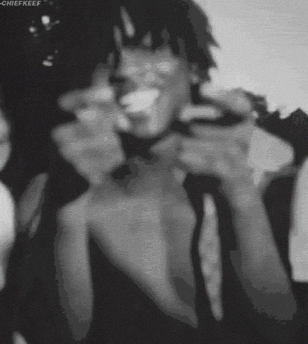A Black And White Photo Of A Man Smoking A Cigarette With The Name Chiefkeef At The Bottom GIF