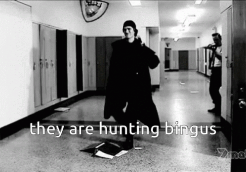 A Black And White Photo Of A Man Standing In A Hallway With The Words They Are Hunting Bingus GIF