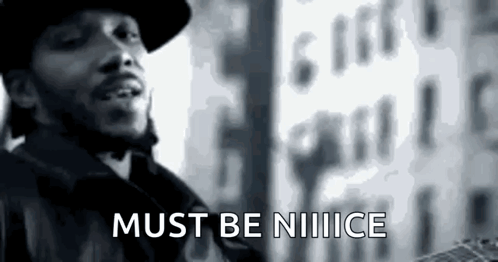 A Black And White Photo Of A Man Standing In Front Of A Building With The Words `` Must Be Notice '' . GIF