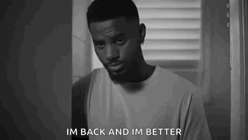 A Black And White Photo Of A Man Standing In Front Of A Window And Saying `` Im Back And Im Better '' . GIF