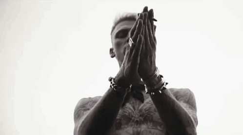 A Black And White Photo Of A Man Standing In Front Of A Window With His Hands In The Air . GIF
