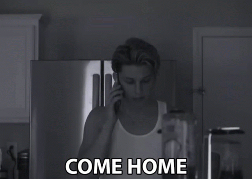 A Black And White Photo Of A Man Talking On A Cell Phone With The Words Come Home Written Below Him GIF