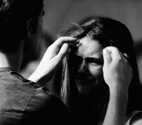A Black And White Photo Of A Man Touching A Woman 'S Head . GIF