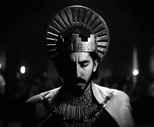 A Black And White Photo Of A Man Wearing A Crown On His Head GIF