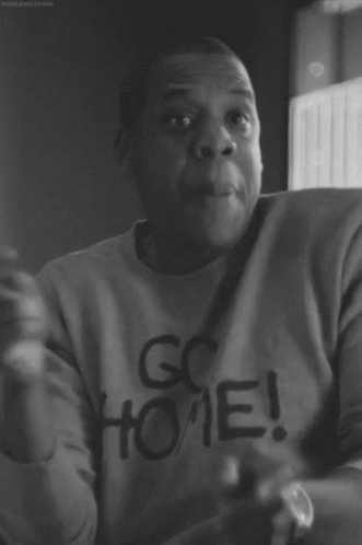 A Black And White Photo Of A Man Wearing A Go Home Sweatshirt GIF