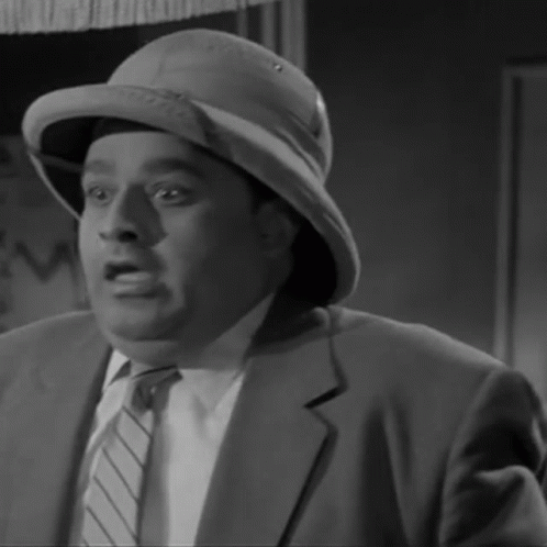 A Black And White Photo Of A Man Wearing A Hat GIF