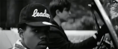 A Black And White Photo Of A Man Wearing A Hat That Says Leader GIF