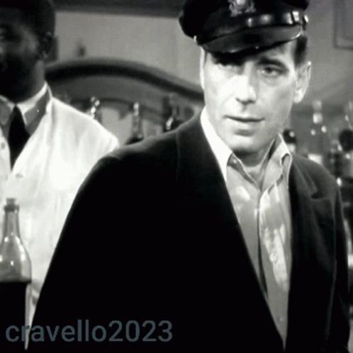 A Black And White Photo Of A Man Wearing A Hat With The Year 2023 On The Bottom GIF