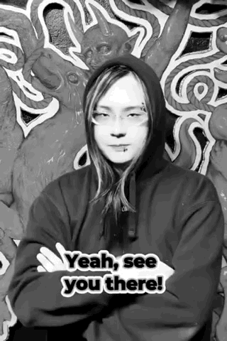 A Black And White Photo Of A Man Wearing A Hoodie And Glasses . GIF