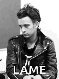 A Black And White Photo Of A Man Wearing A Leather Jacket And A Black Shirt . GIF