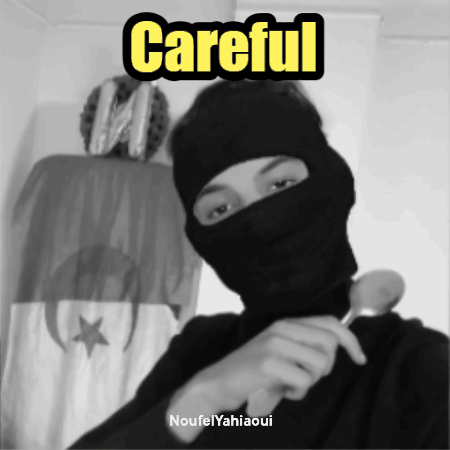 A Black And White Photo Of A Man Wearing A Mask With The Words Careful Written Above Him GIF