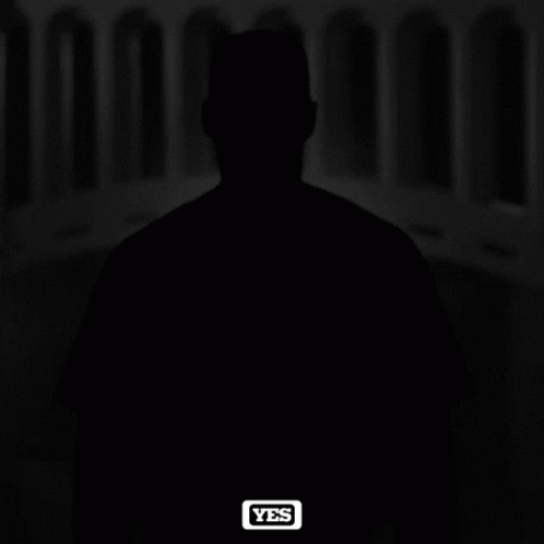 A Black And White Photo Of A Man Wearing A Ny Yankees Hat GIF