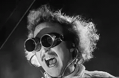 A Black And White Photo Of A Man Wearing A Pair Of Goggles . GIF