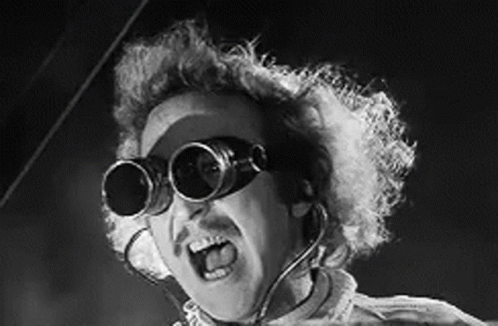 A Black And White Photo Of A Man Wearing A Pair Of Goggles . GIF