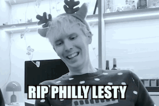 A Black And White Photo Of A Man Wearing A Reindeer Headband . GIF