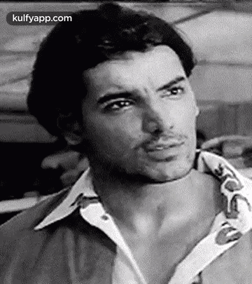 A Black And White Photo Of A Man Wearing A Shirt And Making A Funny Face . GIF