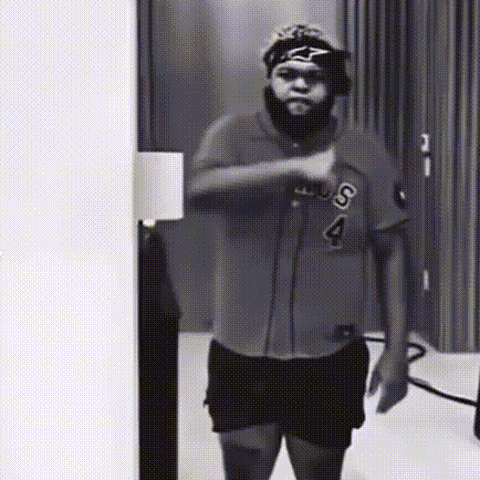 A Black And White Photo Of A Man Wearing A Shirt With The Letter S On It GIF