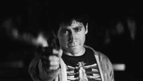 A Black And White Photo Of A Man Wearing A Skeleton Shirt Giving The Middle Finger . GIF