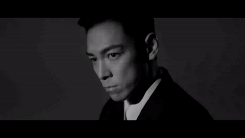 a black and white photo of a man wearing a suit