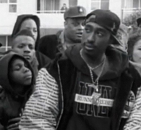 A Black And White Photo Of A Man Wearing A Sweatshirt That Says ' Runnin ' On It GIF