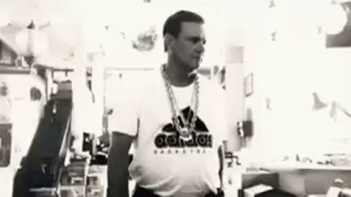 A Black And White Photo Of A Man Wearing A White Adidas T-Shirt . GIF