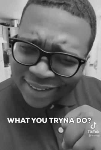 A Black And White Photo Of A Man Wearing Glasses And A Shirt That Says What You Tryna Do GIF