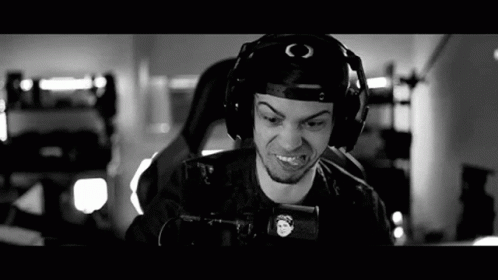 a black and white photo of a man wearing headphones and holding a gun .