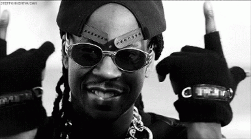A Black And White Photo Of A Man Wearing Sunglasses And A Hat Giving The Middle Finger GIF