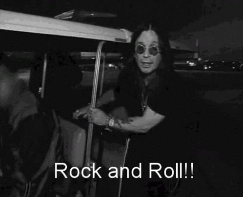 A Black And White Photo Of A Man Wearing Sunglasses And A Shirt That Says Rock And Roll ! GIF