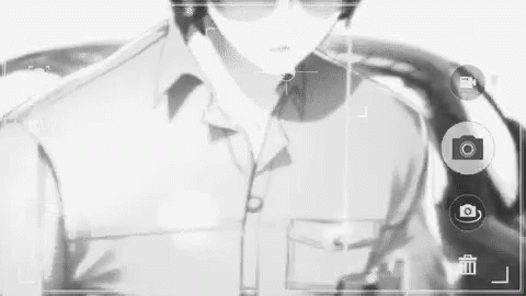 A Black And White Photo Of A Man Wearing Sunglasses And A Suit . GIF
