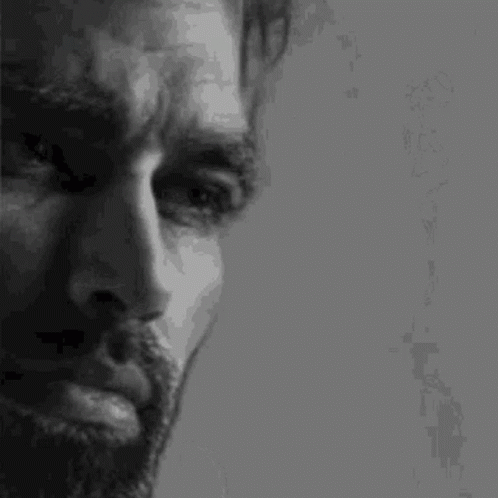 A Black And White Photo Of A Man With A Beard GIF
