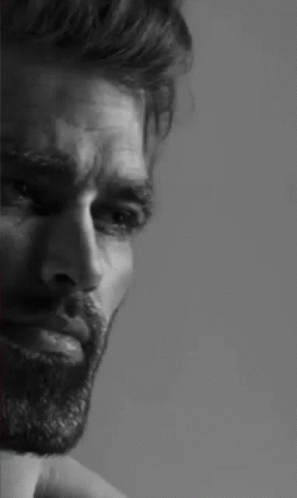A Black And White Photo Of A Man With A Beard And A Serious Look On His Face . GIF