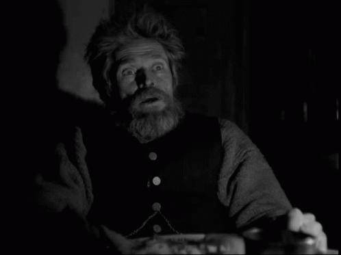 A Black And White Photo Of A Man With A Beard And A Surprised Look On His Face GIF
