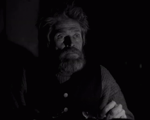A Black And White Photo Of A Man With A Beard And Missing Teeth GIF