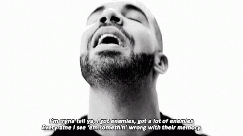 A Black And White Photo Of A Man With A Beard Making A Peace Sign With His Hands . GIF