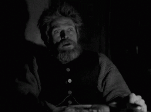 A Black And White Photo Of A Man With A Beard Making A Surprised Face GIF