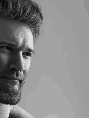 A Black And White Photo Of A Man With A Beard GIF