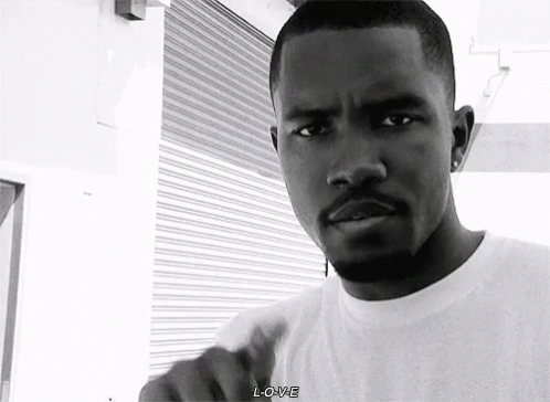 A Black And White Photo Of A Man With A Beard Wearing A White T-Shirt . GIF