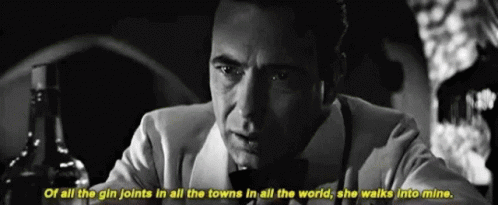 a black and white photo of a man with a bottle of alcohol and the words of all the gin joints in all the towns
