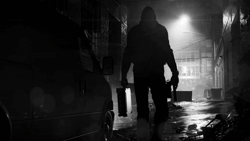 A Black And White Photo Of A Man With A Gun GIF