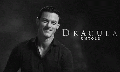 A Black And White Photo Of A Man With Dracula Untold Written In White Letters GIF