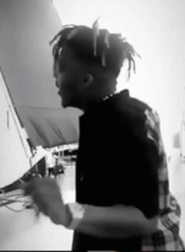 A Black And White Photo Of A Man With Dreadlocks GIF
