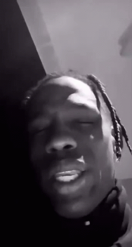 A Black And White Photo Of A Man With Dreadlocks Making A Funny Face With His Eyes Closed . GIF