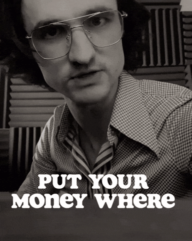 A Black And White Photo Of A Man With Glasses And The Words Put Your Money Where Below Him GIF