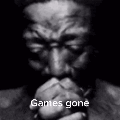A Black And White Photo Of A Man With His Hands Folded And The Words `` Games Gone '' Written On It . GIF