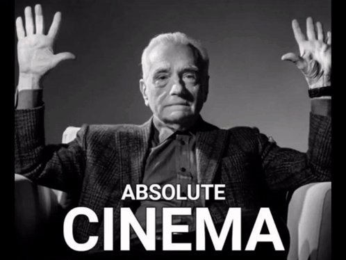 A Black And White Photo Of A Man With His Hands Up And The Words Absolute Cinema Behind Him GIF