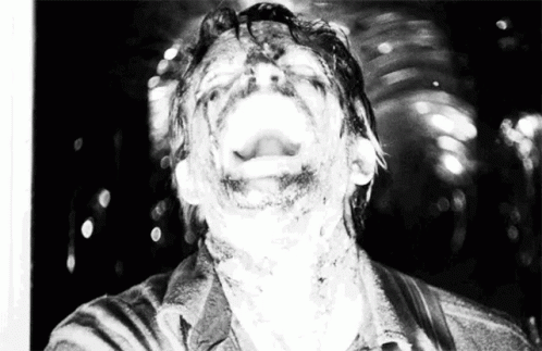 A Black And White Photo Of A Man With His Mouth Wide Open GIF